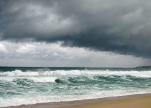 Hurricane winds pushing waves to batter beach.